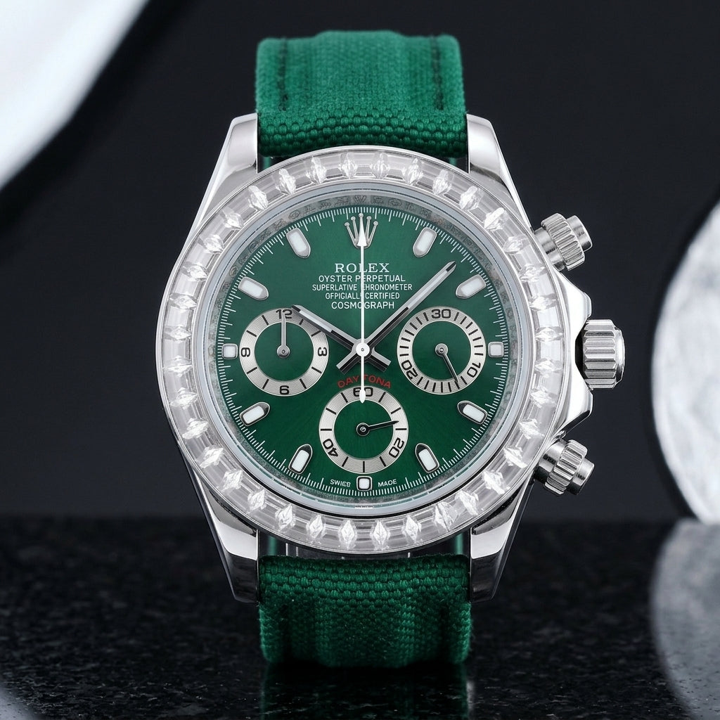 Steel chronograph with a deep green dial on its green canvas strap, worn on the wrist below a dark suit cuff