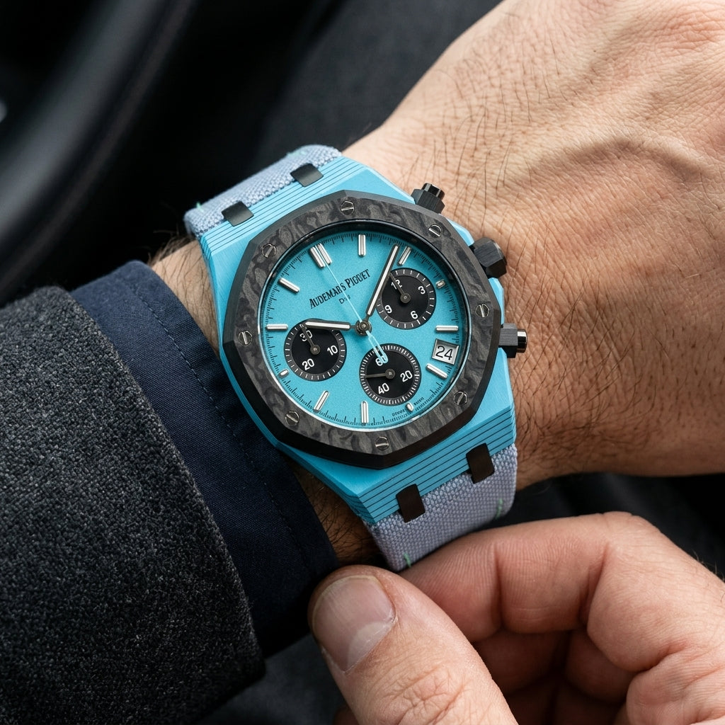 Octagonal chronograph with a sky-blue case and a sky-blue dial on the wrist as a shirt cuff is fastened