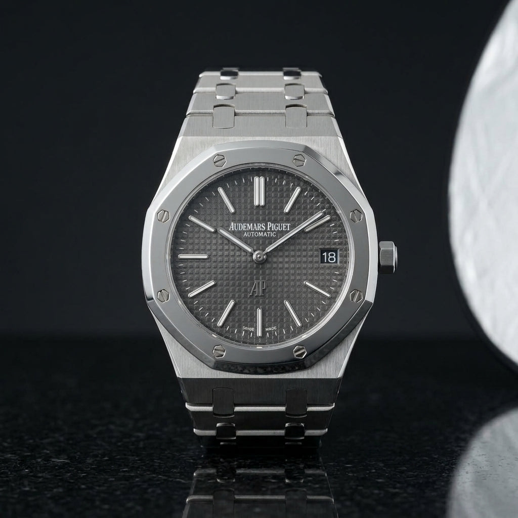Extra-thin steel octagonal sports watch on its integrated bracelet, worn under a shirt cuff