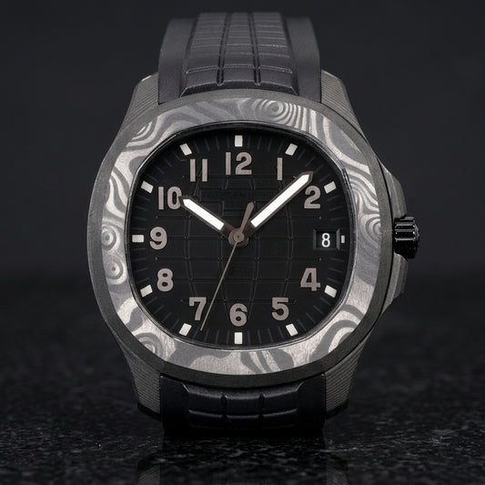 Forged-carbon watch with a black grid dial and gunmetal-grey numerals, upright on polished black granite