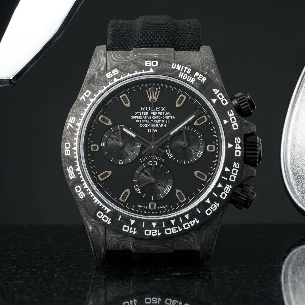 All-black forged-carbon chronograph with a matte black dial on dark stone