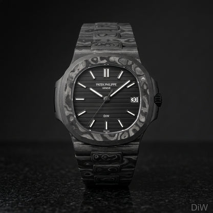All black carbon sports watch and carbon bracelet upright on black granite