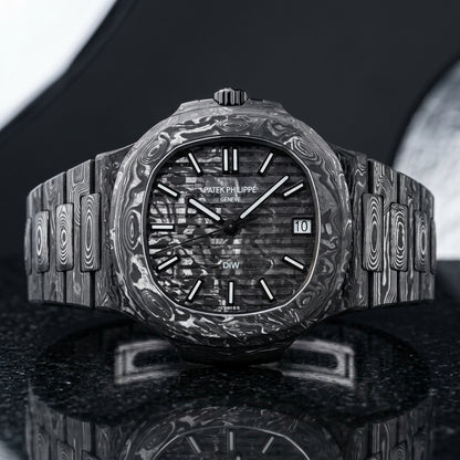 Forged carbon sports watch with a grooved black and silver-white carbon dial, upright on polished black granite