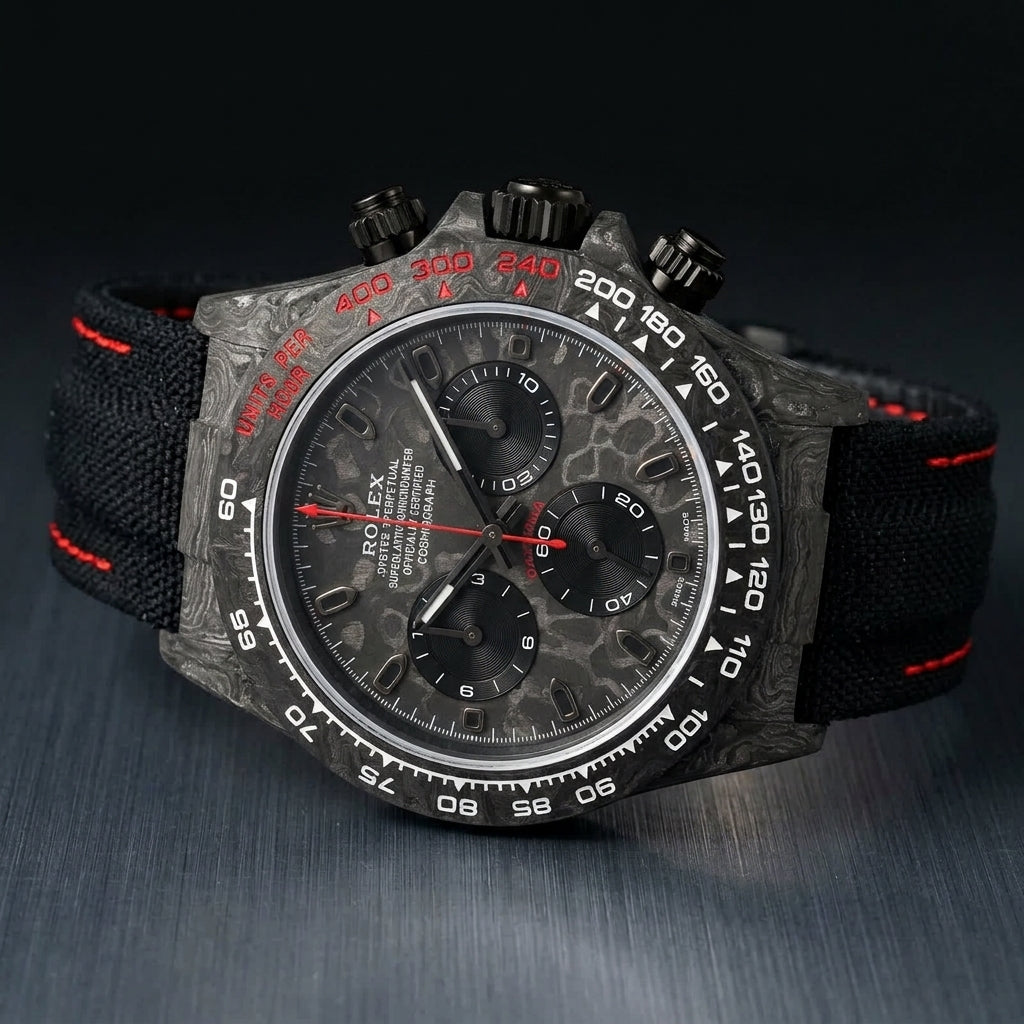Forged-carbon chronograph at a three-quarter angle, red lettering visible on the marbled carbon dial