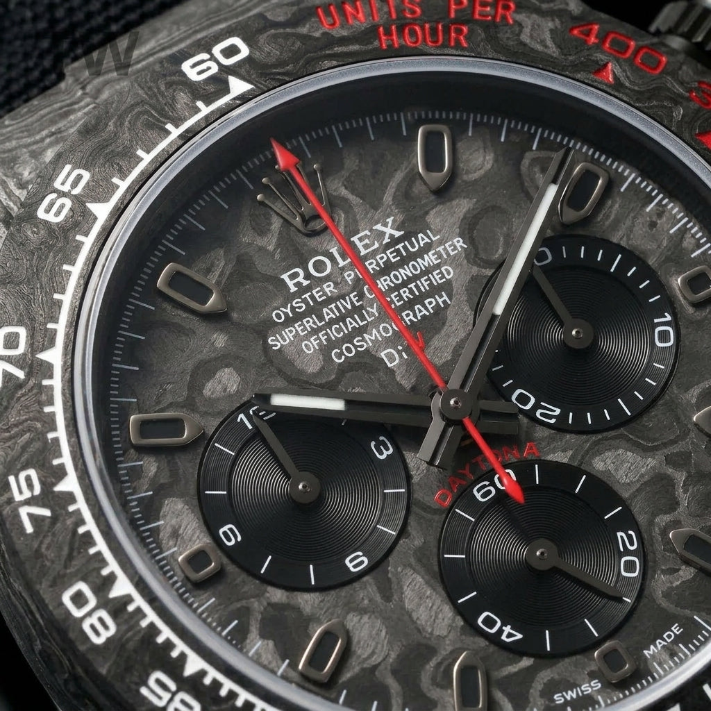 Macro of the carbon dial, its three turntable-brushed black counters and the red chronograph hand