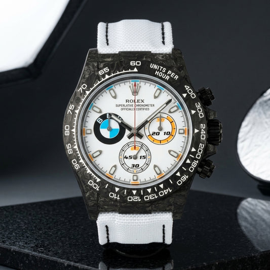 Black forged-carbon chronograph with a white dial on black granite