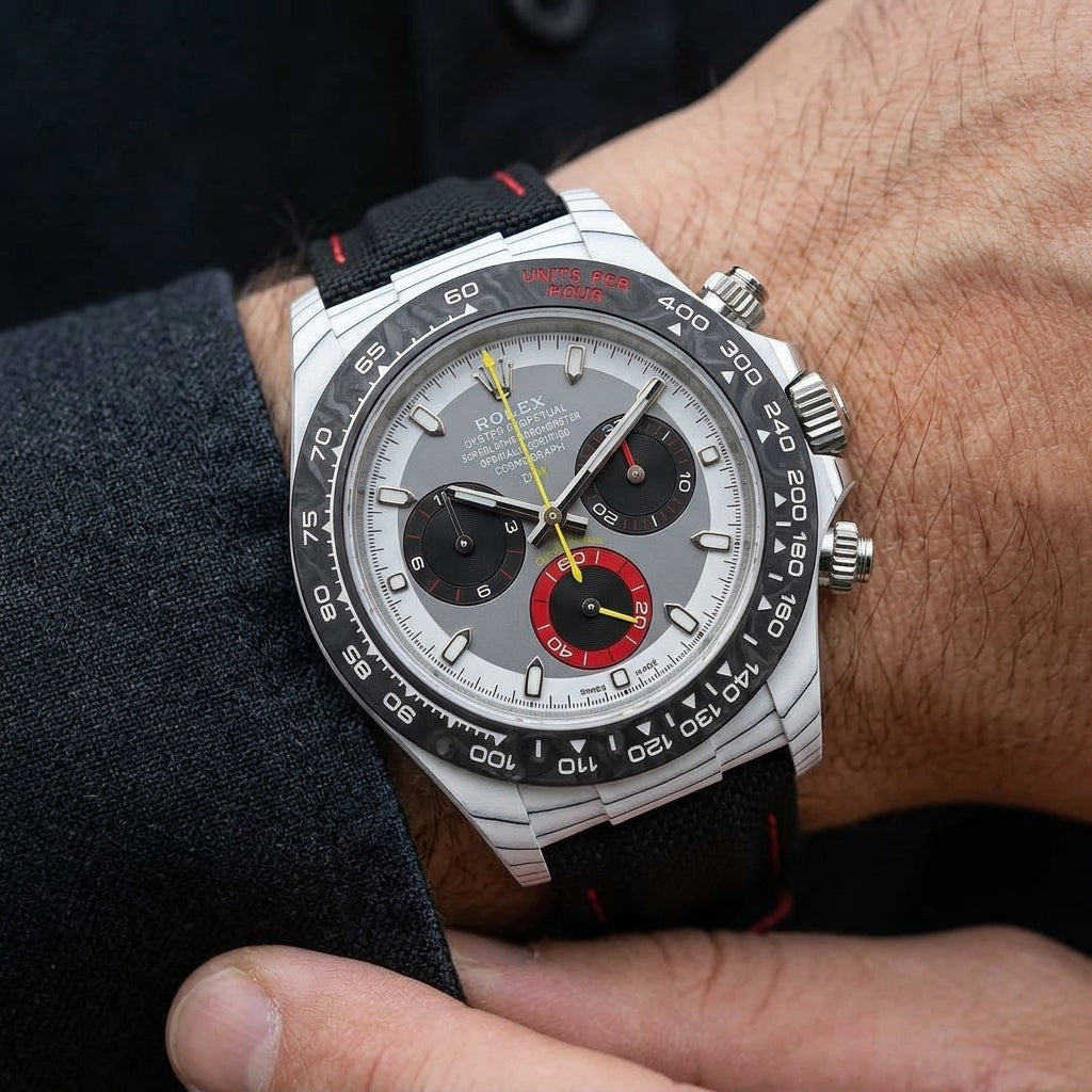 White forged carbon chronograph with a grey dial and a red counter on the wrist as a shirt cuff is fastened