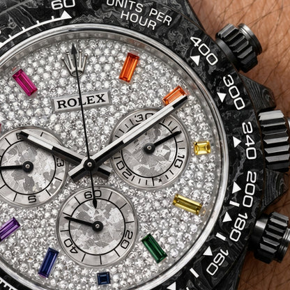 Macro of the white pavé dial, its rainbow gemstone hour markers and three grey meteorite-textured counters