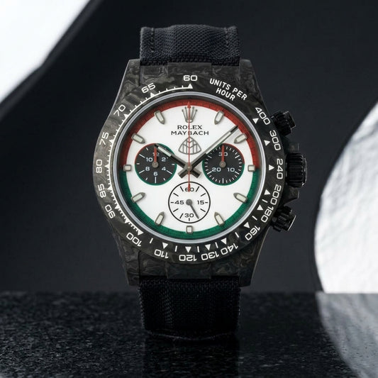 Black forged-carbon chronograph with a red and green ringed dial on black granite