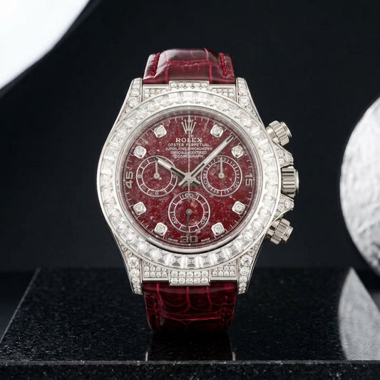 White gold chronograph with a red stone dial and baguette bezel on black granite