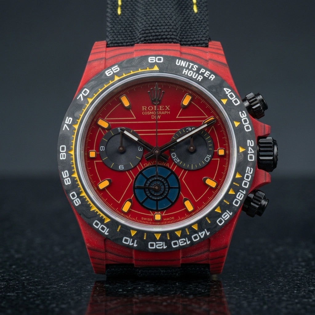 Red forged-carbon chronograph on a black woven strap with yellow stitching, worn under a cuff