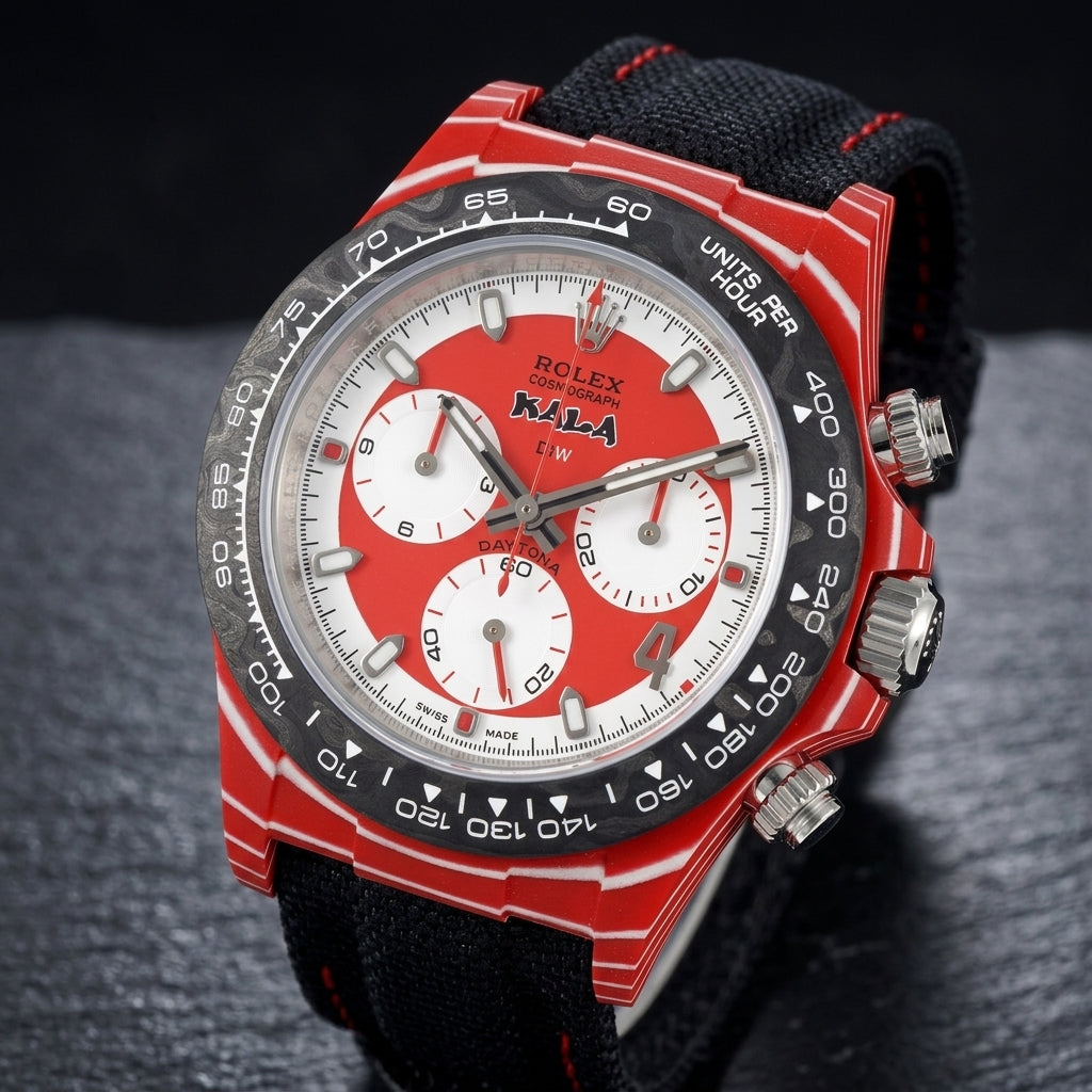 Red carbon chronograph at a three-quarter angle on dark slate, the white-striped flank beside the polished steel crown and pushers