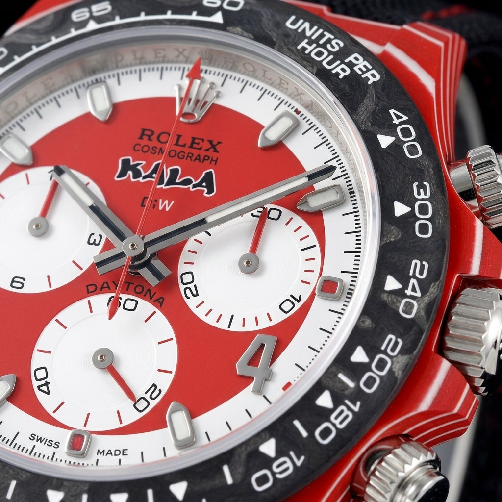 Macro of the red-and-white dial with three white counters and an applied steel 4 inside the black carbon tachymeter bezel