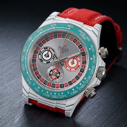 White carbon chronograph at a three-quarter angle on dark slate, the teal bezel beside the fluted steel crown and pushers