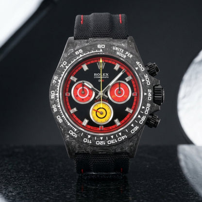 Forged carbon racing chronograph with black and red dial and yellow counter on black granite