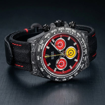 Red racing carbon chronograph at a three-quarter angle on dark slate