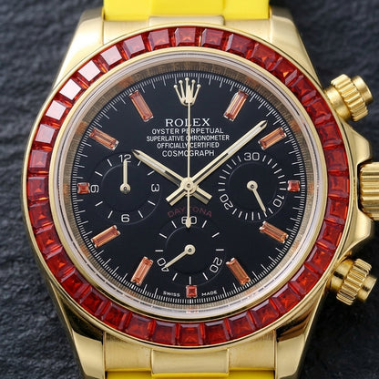 Macro of the black dial with orange baguette markers and three black counters inside the ring of red baguette-cut stones