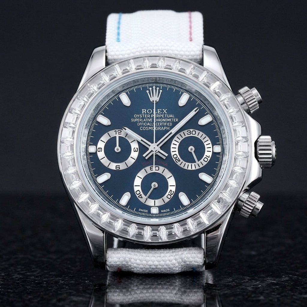 Steel chronograph with a deep blue dial and a bezel of clear baguette-cut stones, upright on polished black granite