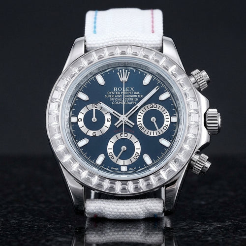 Steel chronograph with a deep blue dial and a bezel of clear baguette-cut stones, upright on polished black granite
