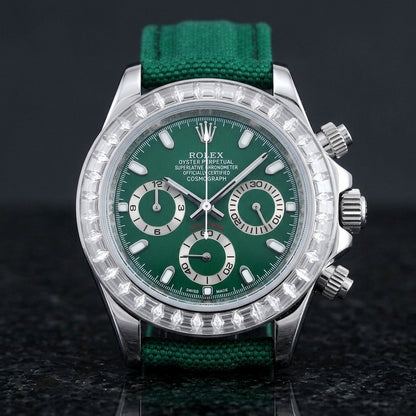 Steel chronograph with a deep green dial and a bezel of clear baguette-cut stones, upright on polished black granite