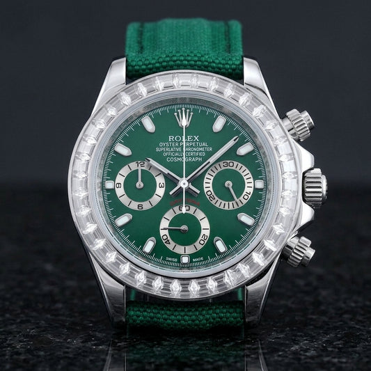 Steel chronograph with a deep green dial and a bezel of clear baguette-cut stones, upright on polished black granite