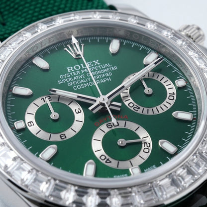 Macro of the deep green dial with white print, steel baton markers and three silver counters inside the ring of clear baguette stones