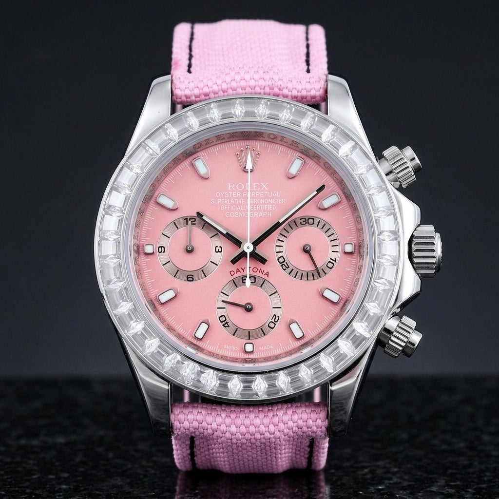Steel chronograph with a pink dial and a bezel of clear baguette-cut stones, upright on polished black granite
