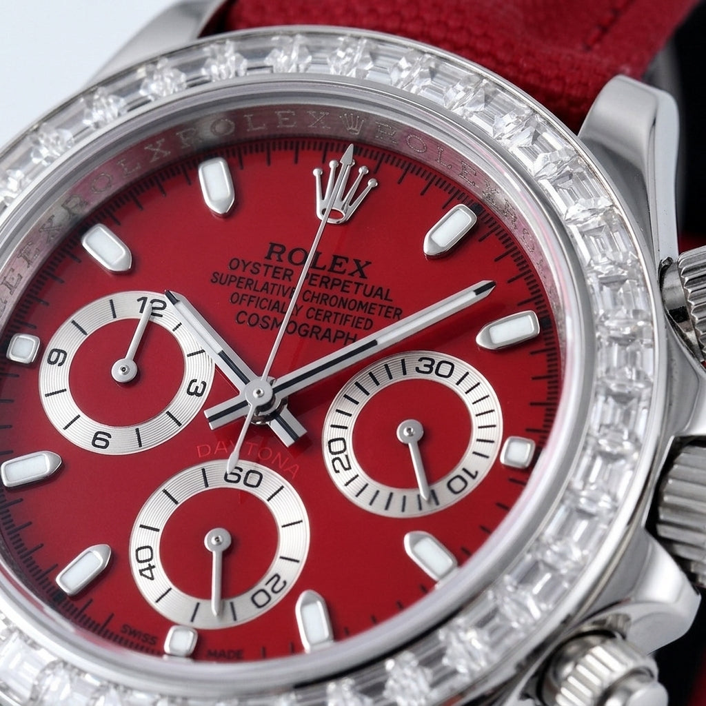 Macro of the cherry-red dial with steel baton markers and three silver counters inside the ring of clear baguette-cut stones