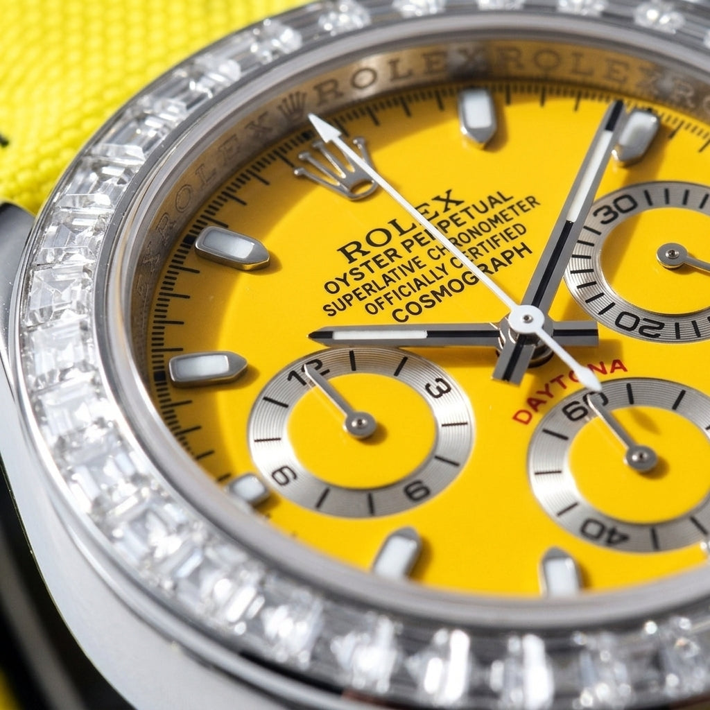 Macro of the sunflower-yellow dial with steel baton markers and three silver counters inside the ring of clear baguette-cut stones