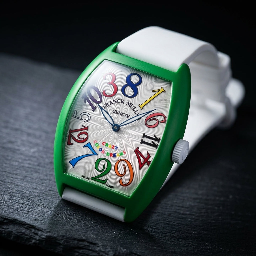 Green curved tonneau watch at a three-quarter angle on dark slate, its white fluted crown on the matte green flank