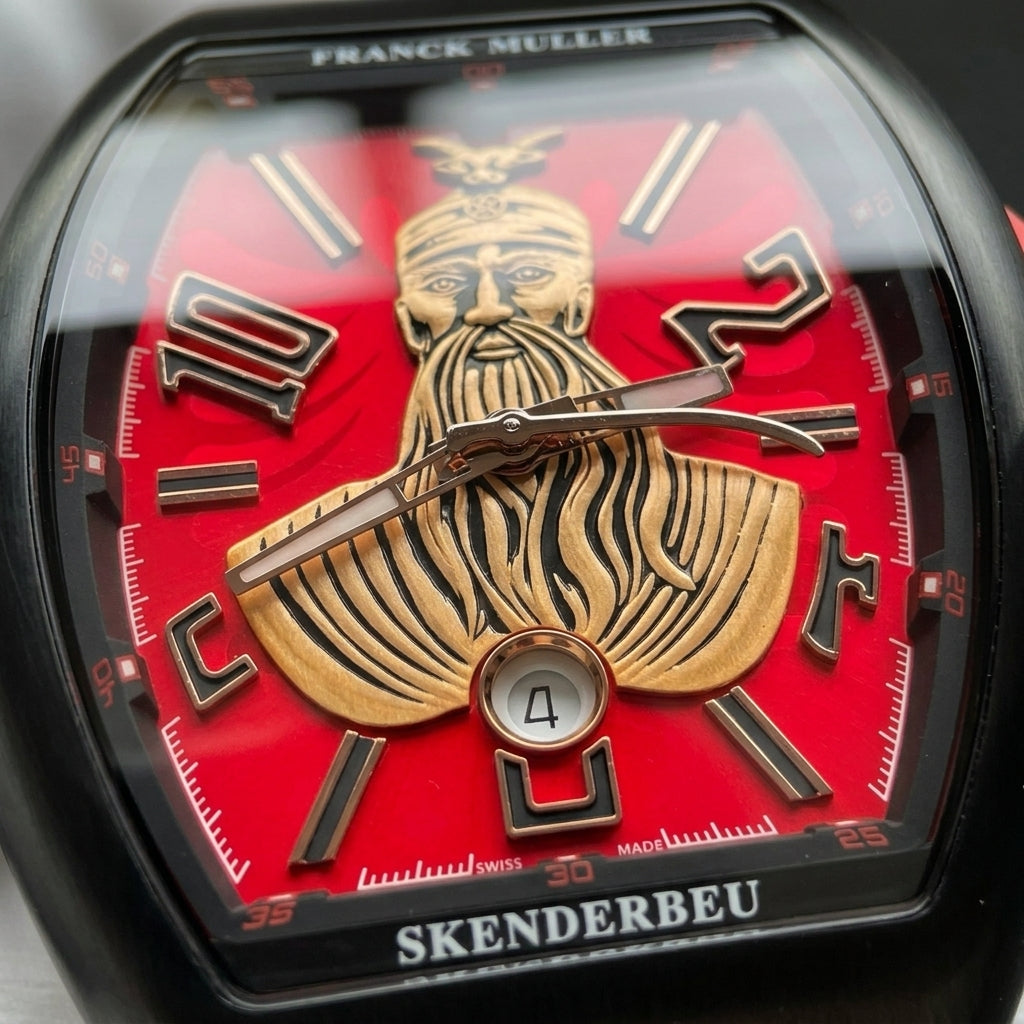 Macro of the red dial with the gold-tone bearded warrior bust, the round date window and the black numerals edged in rose gold