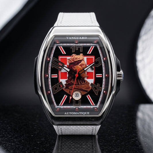 Steel curved tonneau watch with a black dial, a red-and-white checkerboard and a crowned king portrait, upright on polished black granite