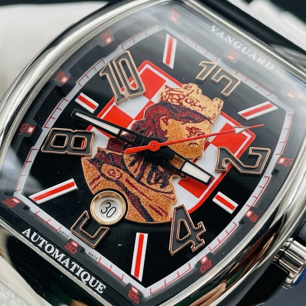 Macro of the black dial: the crowned king in copper tones on the red-and-white checkerboard, black numerals outlined in rose-gold