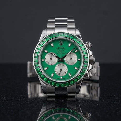 Steel chronograph with emerald green dial and green stone bezel on black granite