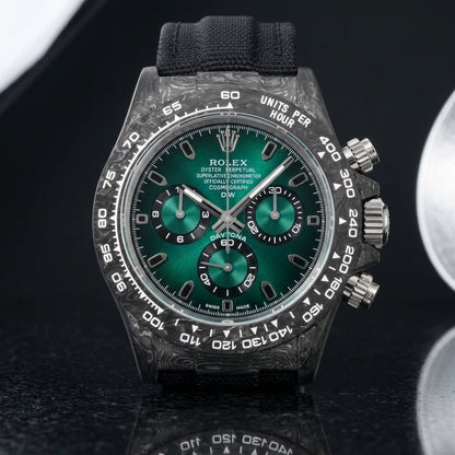 Forged-carbon chronograph with a green sun-brushed dial on pale stone