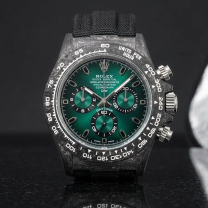 Forged-carbon chronograph on a black woven strap, worn under a cuff