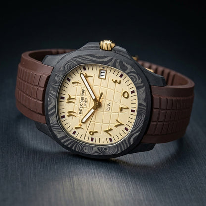 Black forged-carbon grid-dial watch at a three-quarter angle on dark slate, its polished gold fluted crown and chocolate-brown rubber strap in view