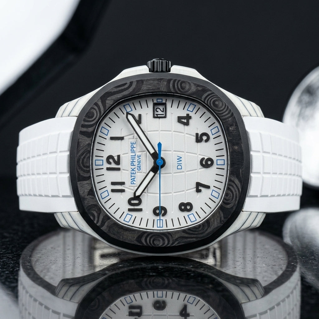 White carbon watch with a black bezel on a white rubber strap, worn on the wrist below a navy suit cuff