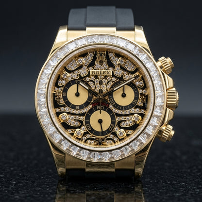 Yellow gold chronograph with a black pavé leopard dial and a clear baguette bezel, upright on polished black granite