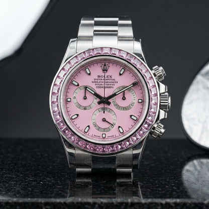 Steel chronograph with pale pink dial and pink stone bezel on black granite