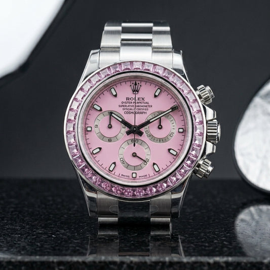 Steel chronograph with pale pink dial and pink stone bezel on black granite