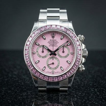 Pink dial steel chronograph worn under a navy suit cuff