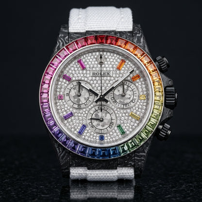 Black forged carbon chronograph with a rainbow gemstone bezel set in steel and a white pavé dial, upright on polished black granite