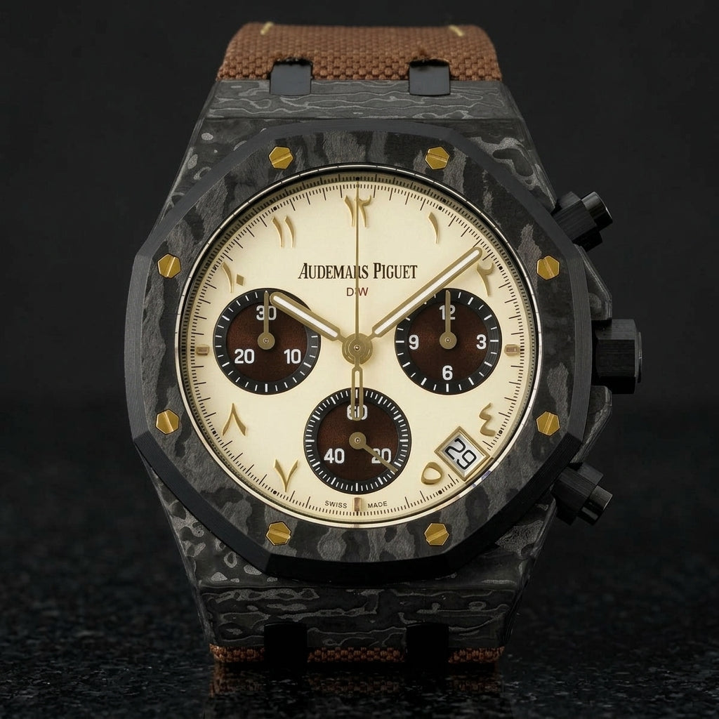 Black forged-carbon octagonal chronograph with a cream dial on its brown canvas strap, worn on the wrist below a dark suit cuff