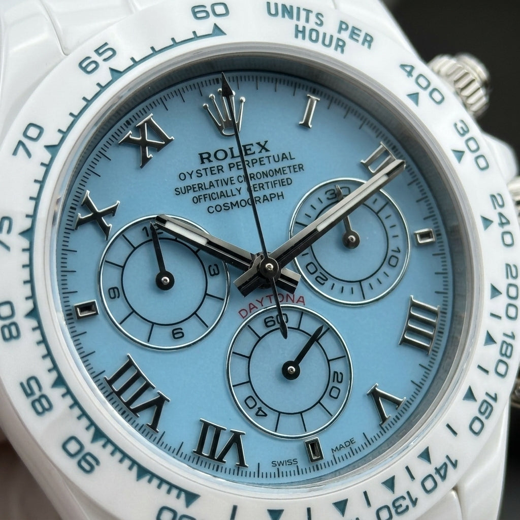 Macro of the light blue dial with polished steel Roman numerals and three steel-ringed counters