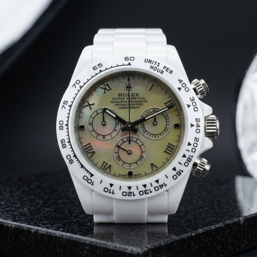 White ceramic chronograph with a green mother-of-pearl dial and Roman numerals, upright on polished white marble