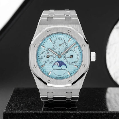 Octagonal calendar watch and integrated bracelet on polished black granite