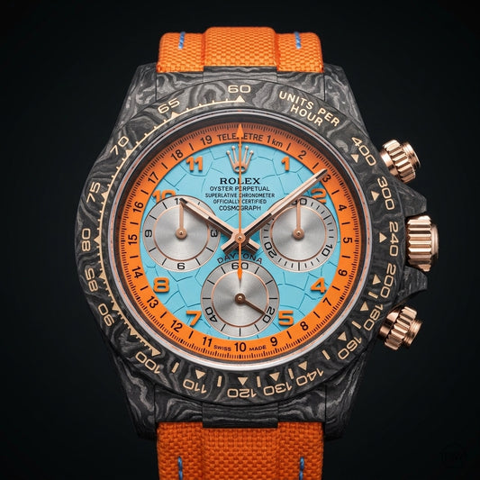 Forged-carbon chronograph with a pale ice-blue telemetre dial and orange numerals on dark stone