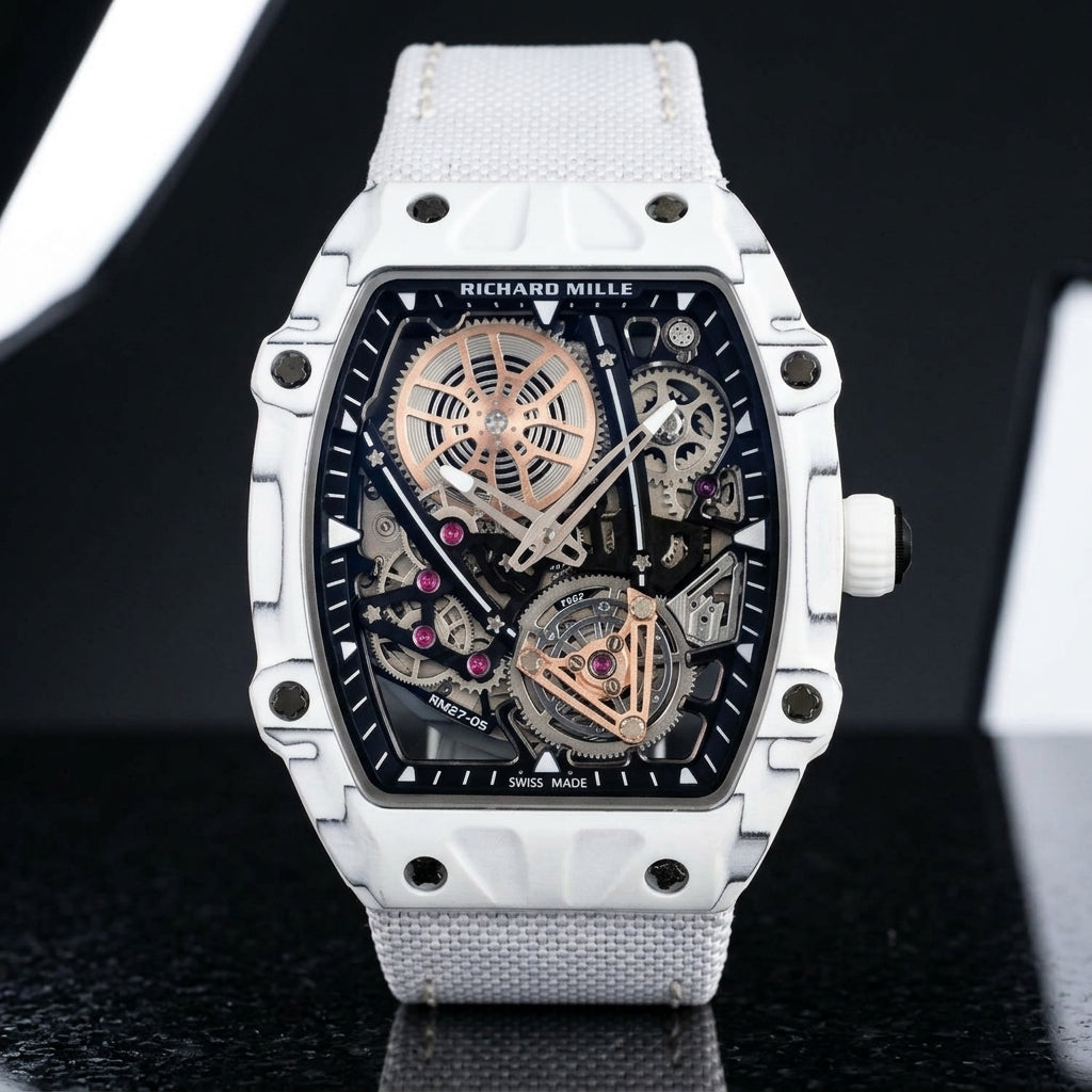 All-white thin-ply carbon tonneau watch with an open skeleton dial and a white woven strap, upright on polished black granite