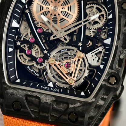 Macro of the open skeleton dial: the rose-gold spoked wheel at the upper left, pink jewels, and the tourbillon-style cage at six under a rose-gold bridge